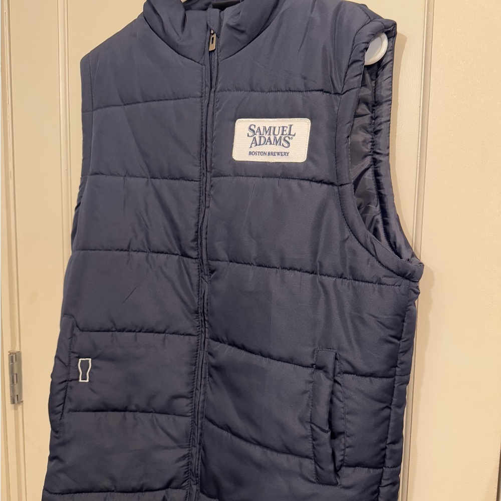 Blue sleeveless puffer vest with stand-up collar and quilted design